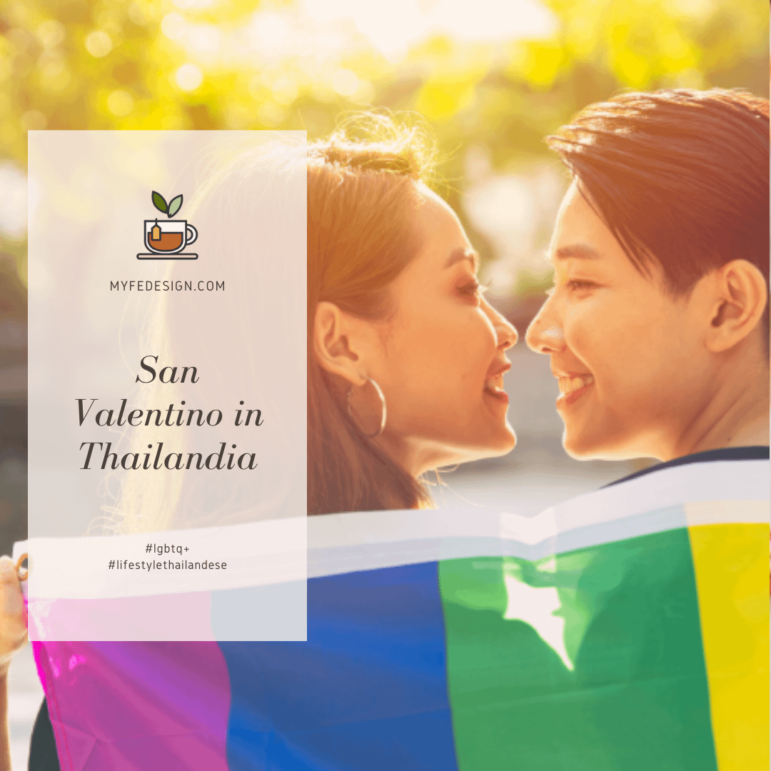 coppia LGBTQ+ thailandese che si sorridono abbracciati ad una bandiera arcobaleno