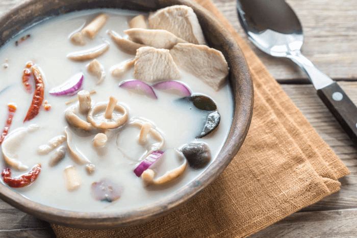 piatto intavolato con la zuppa tom kha gai