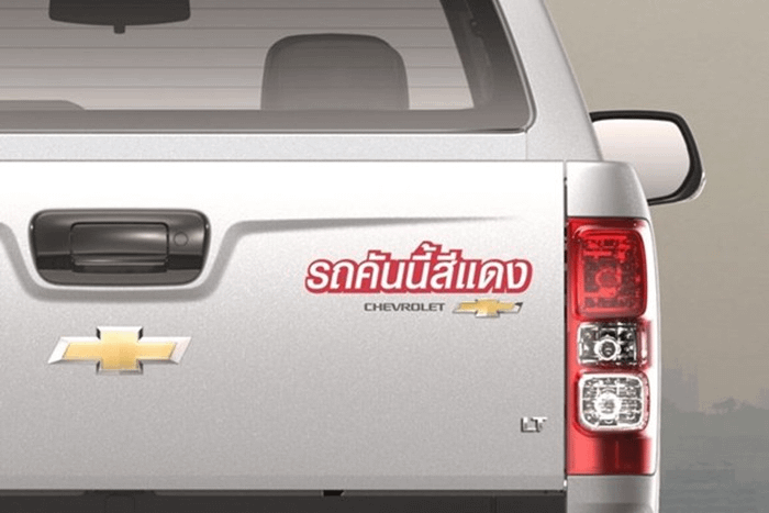 sticker su una chevrolet grigia con su scritto "questa macchina è rossa"