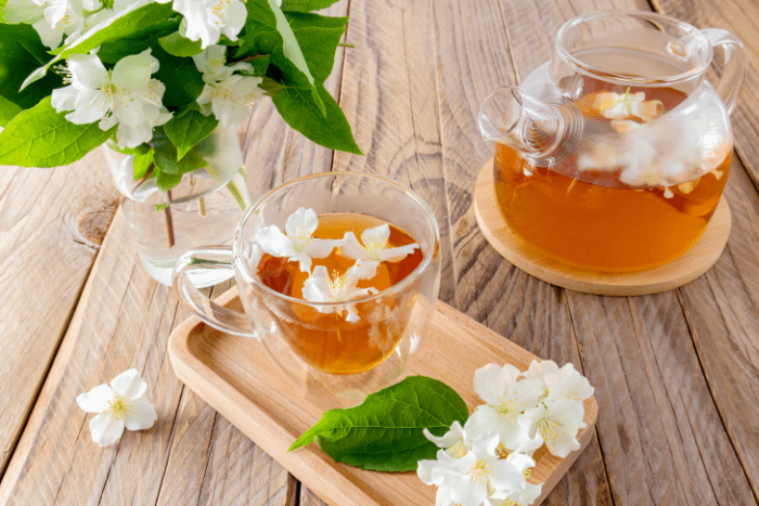 tea composition on a rustic wooden table. a cup of jasmine tea on a tray, a teapot withbrewed tea by mmoskalyuk160462-EnvatoElements